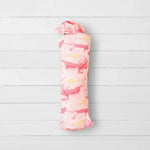 Blush pink swaddle blanket with a soft floral pattern, laid out square