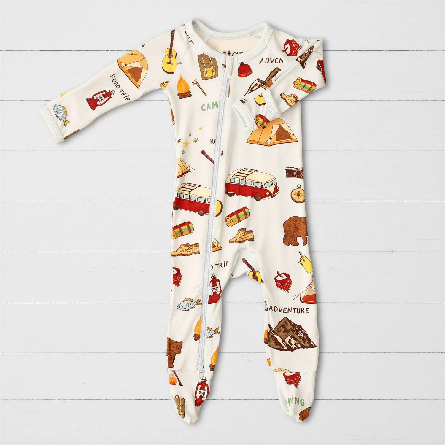 Baby footie pajamas with camping print and a full-length two-way zipper.