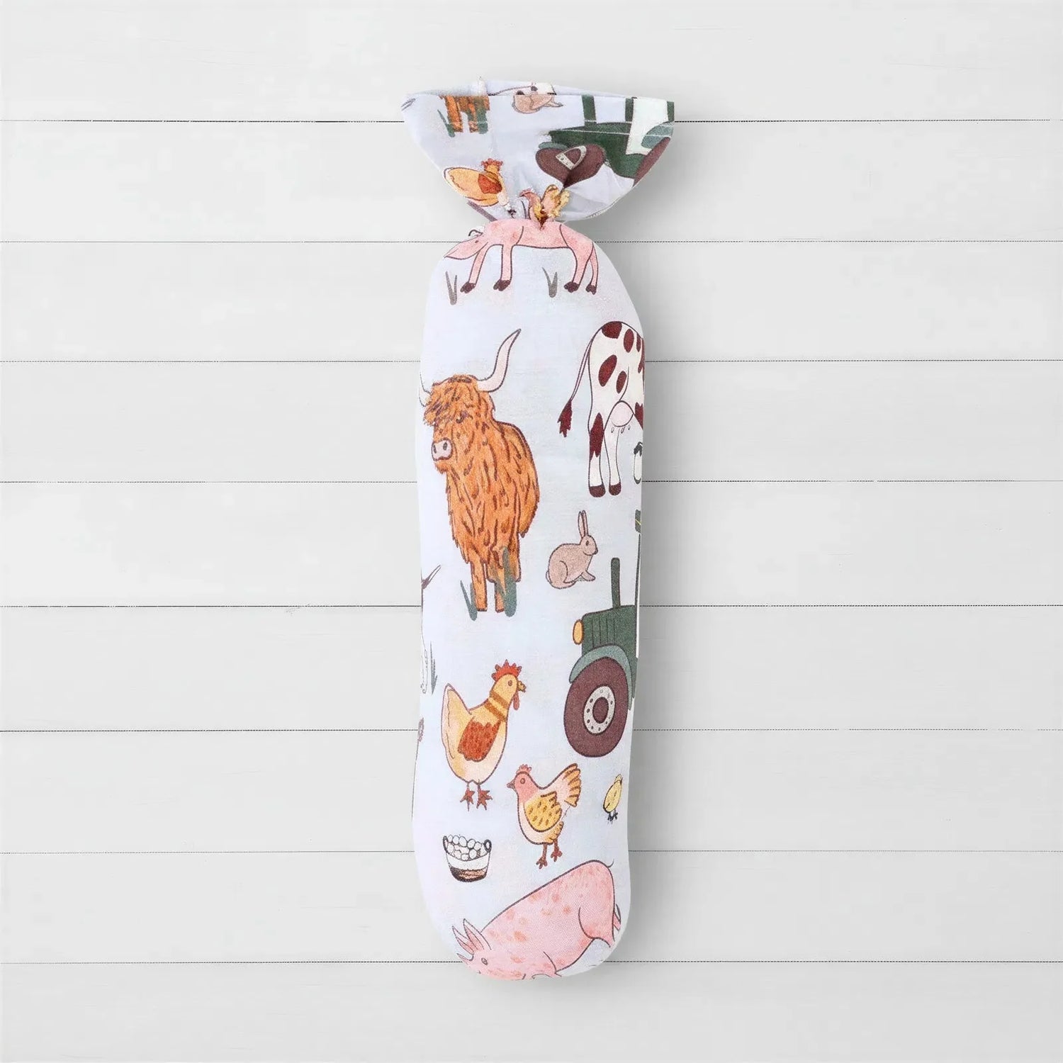 Farm Life swaddle blanket with a farm animal print, spread flat to show the square shape.