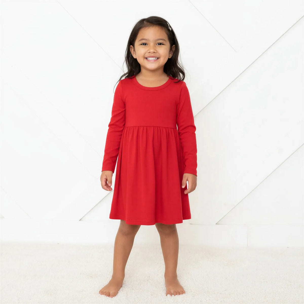 Ruby long sleeve toddler dress in a solid ruby red color with a full twirl skirt