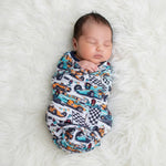 Apex Dreams swaddle blanket with superhero-inspired print spread flat to show the square shape.