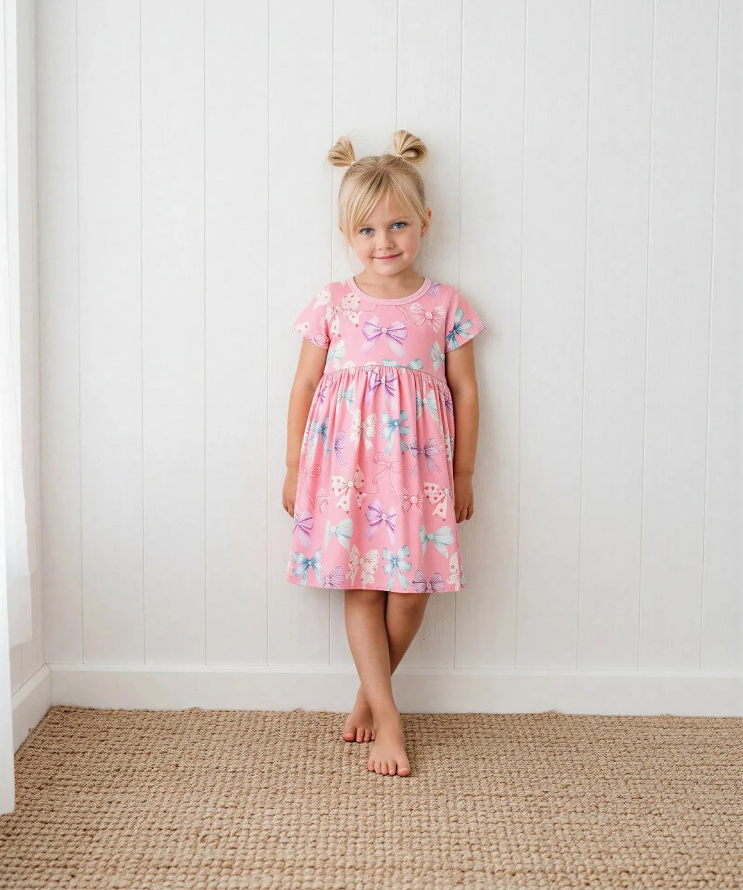 Twinkle Ties dress in pink with tie details and short sleeves, worn by a toddler.