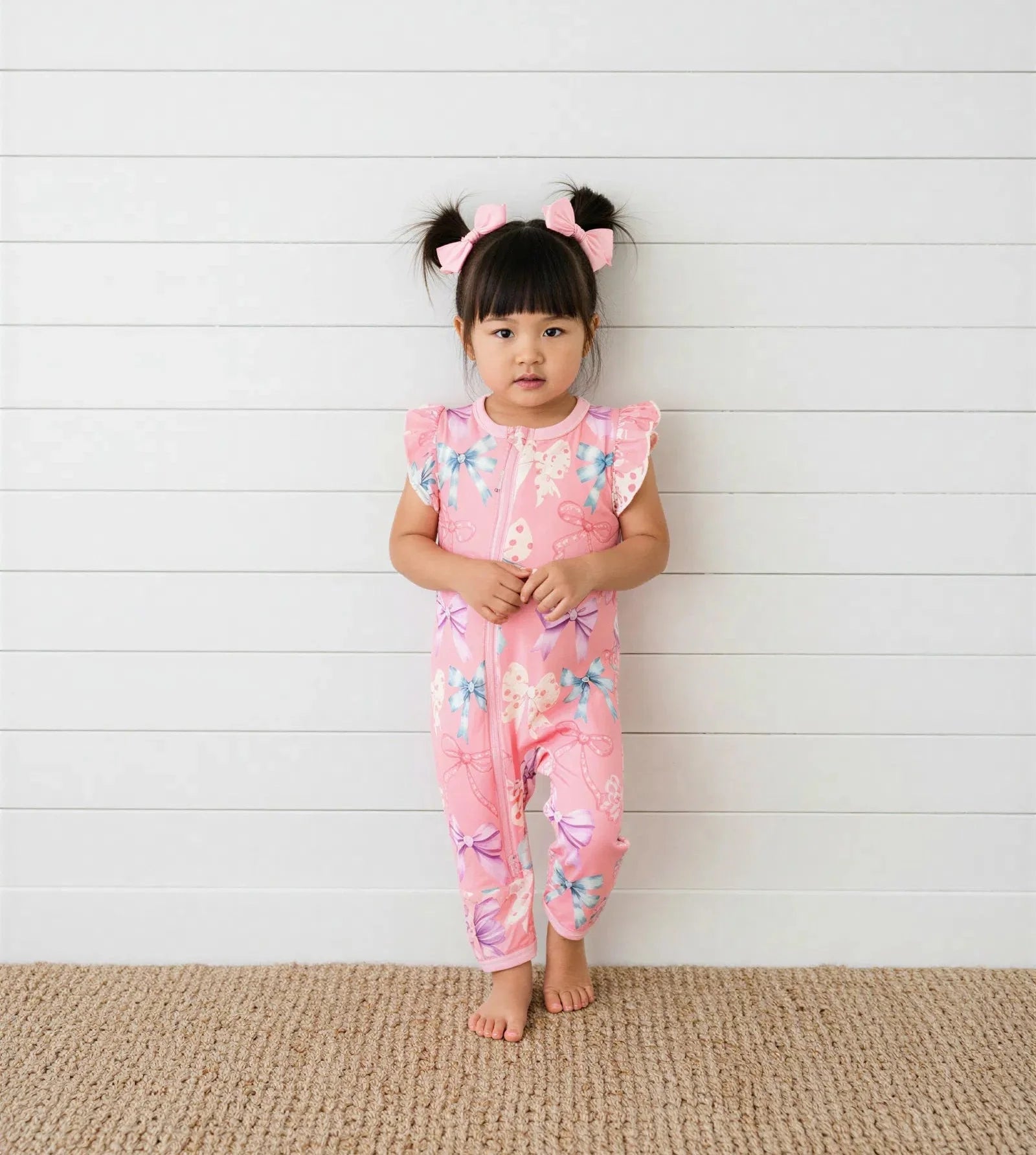 Flutter sleeve romper in pink Twinkle Ties print with dual front zippers