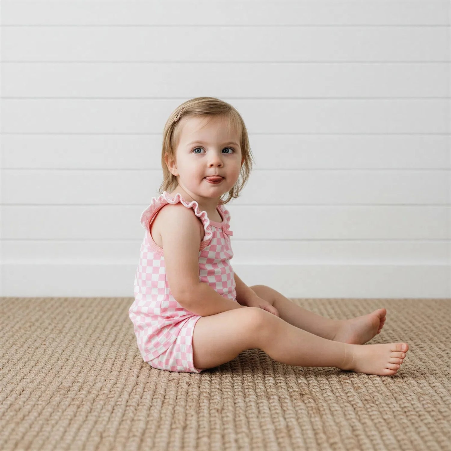Pink checked flutter tank top with ruffled bloomer shorts and matching stretchy headband for a baby girl.
