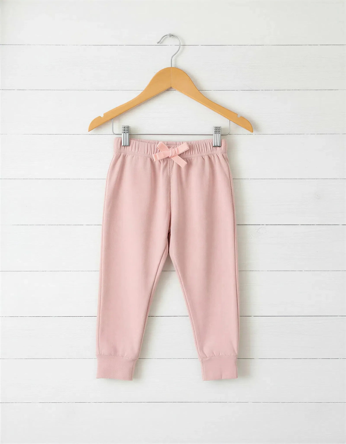 Blush pink relaxed-fit baby joggers with an elastic drawstring waist.