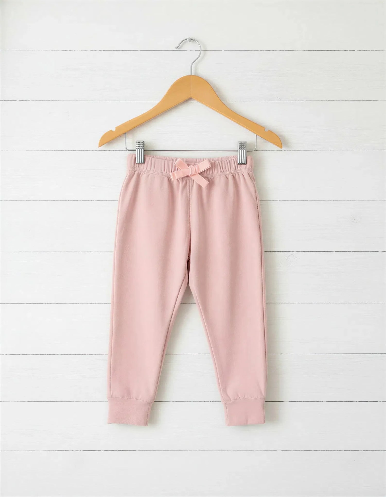Blush pink relaxed-fit baby joggers with an elastic drawstring waist.