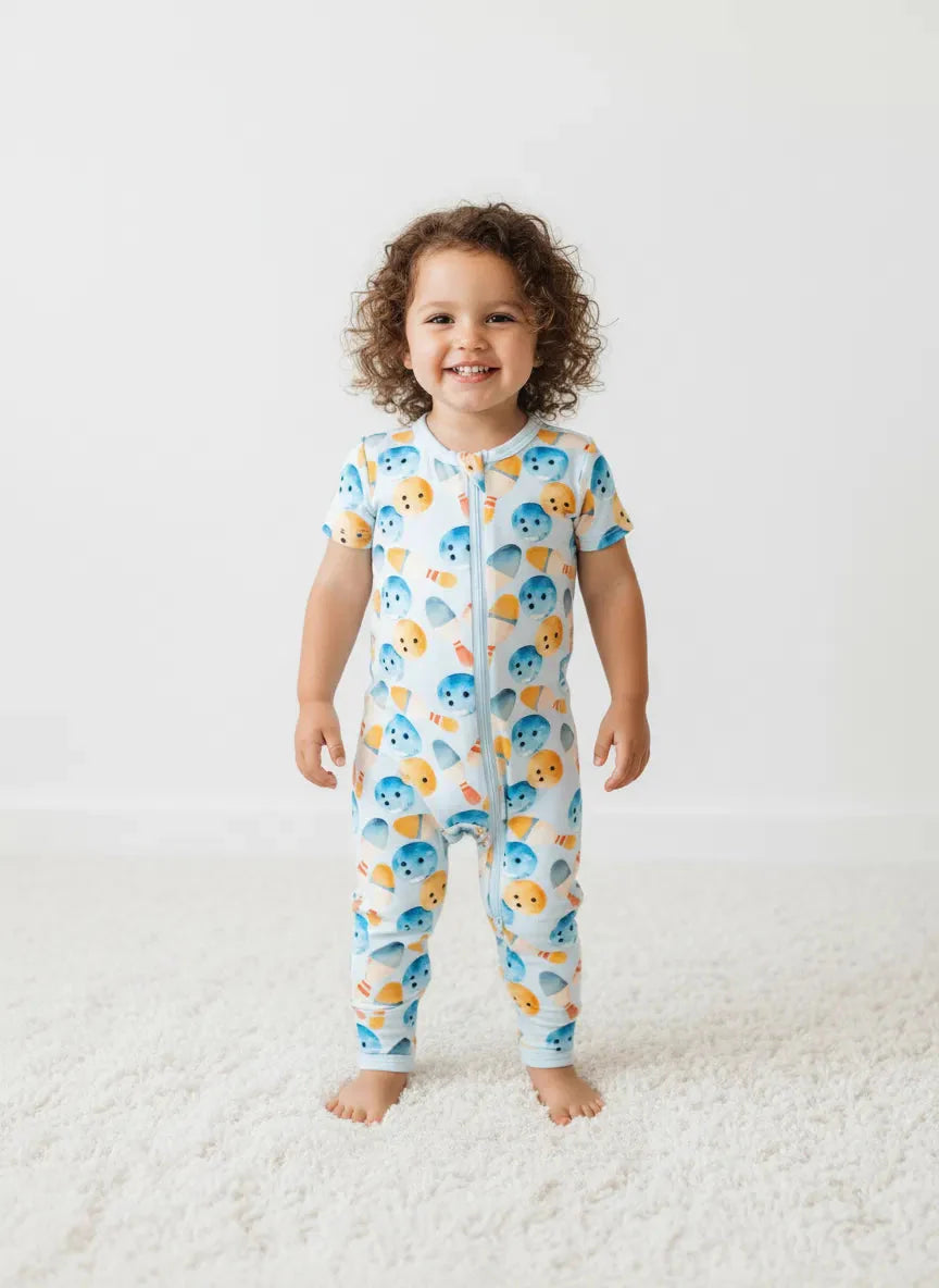Baby coverall in a whimsical bowling print with long sleeves, long legs, and a full-length front zipper.