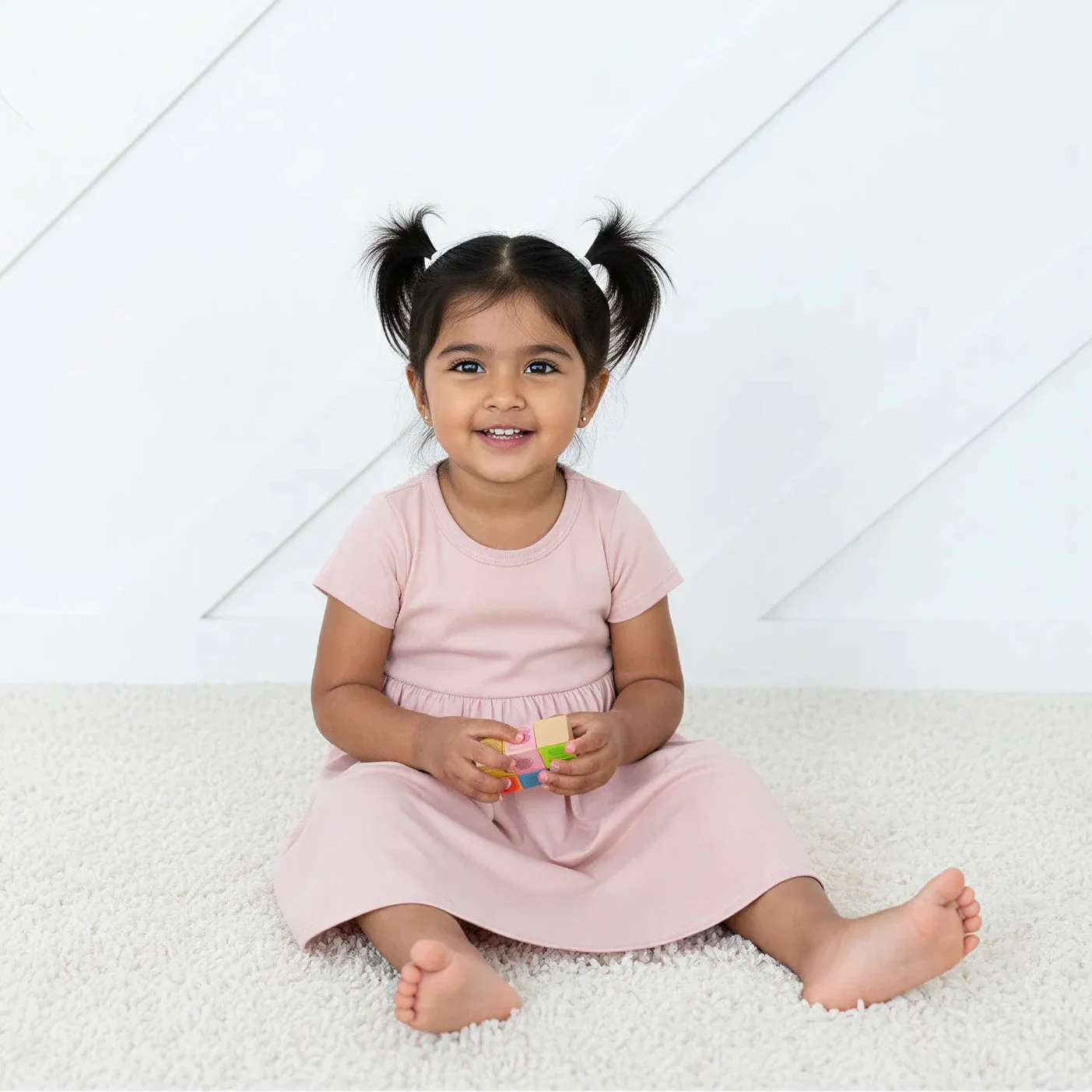 Blush pink short-sleeve baby dress with a full twirl skirt