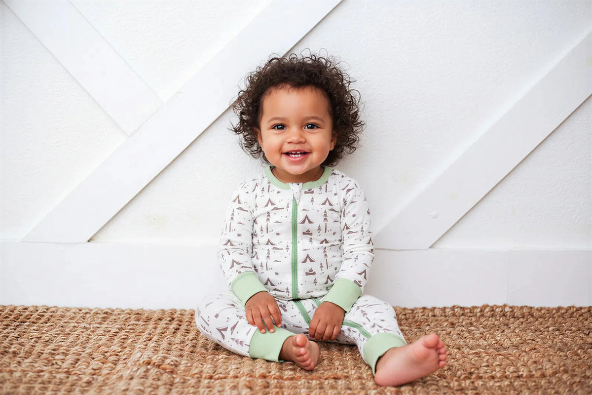 Convertible baby coverall with front zipper and Everglee print, shown in footed style