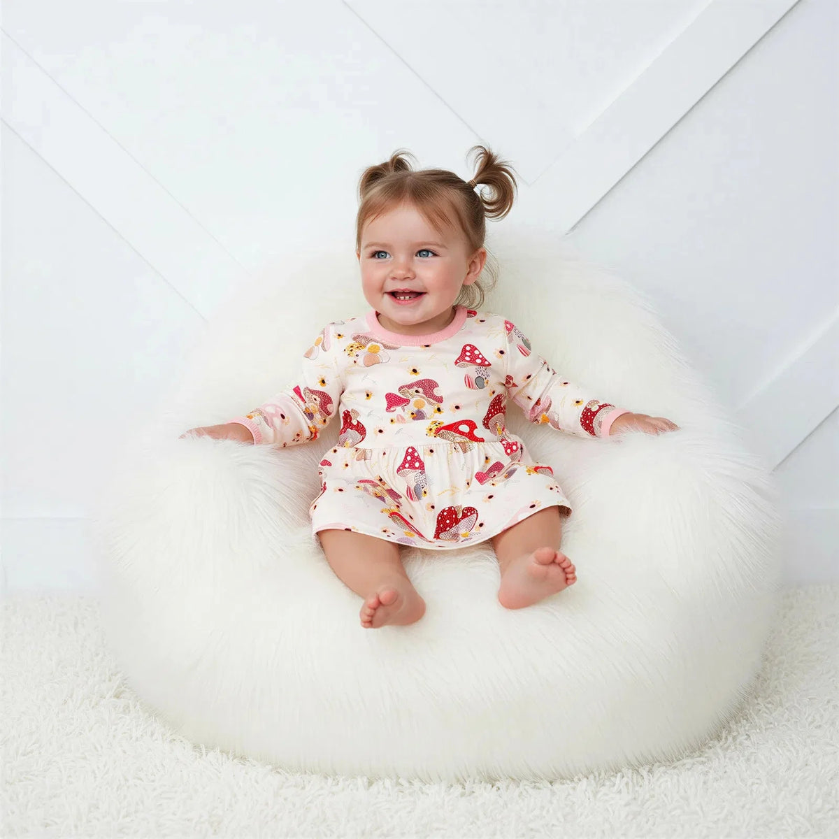 Baby bodysuit dress with long sleeves and a floral mushroom print pattern