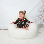 Long-sleeve baby bodysuit dress in a festive holiday style with snap closure at the inseam.