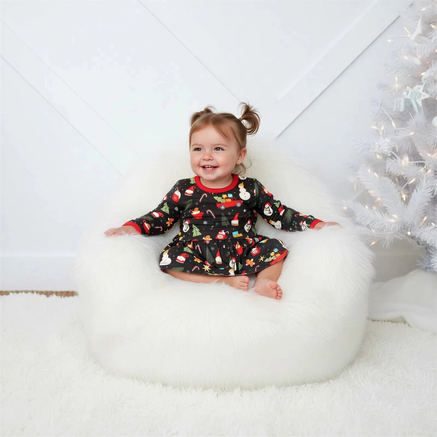 Long-sleeve baby bodysuit dress in a festive holiday style with snap closure at the inseam.