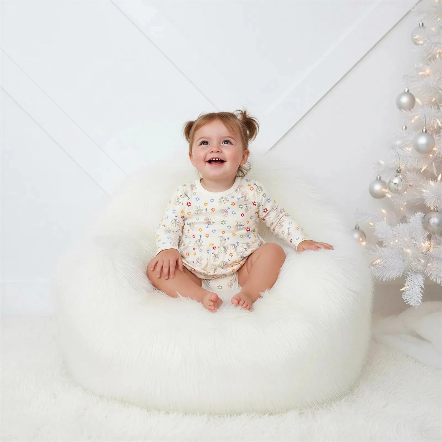 Long-sleeve baby bodysuit dress with a Hanukkah star print and snap closure at the inseam