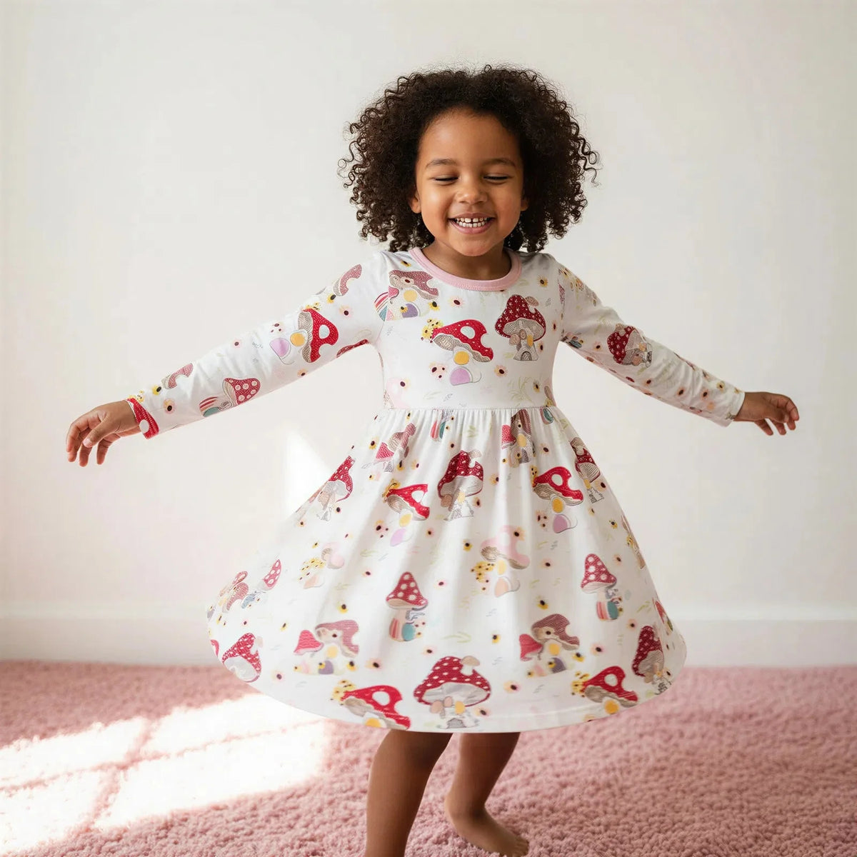 Long-sleeve toddler dress in pink with a whimsical mushroom and floral print