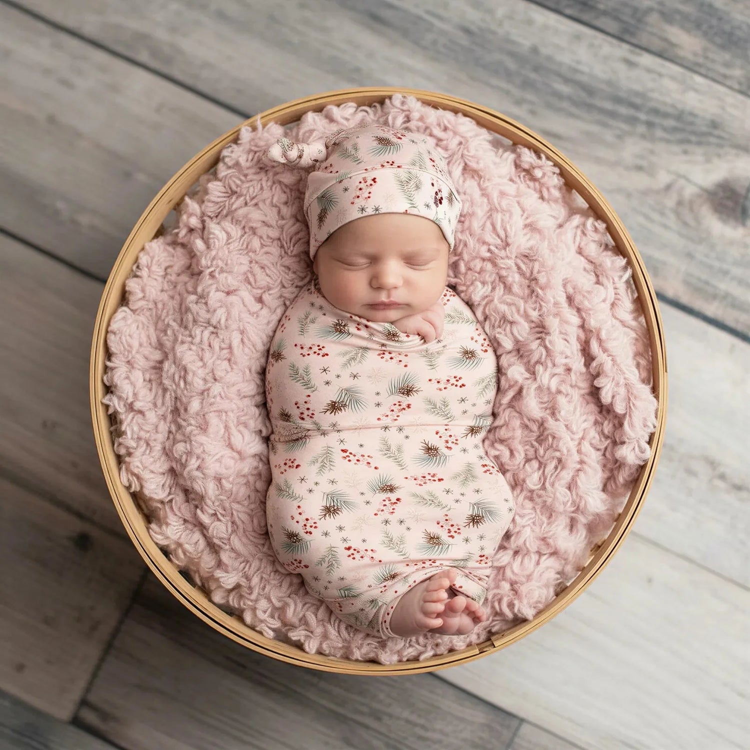Cozy Pines swaddle blanket with a pink pine tree pattern, spread flat