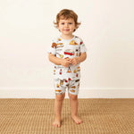 Two-piece short-sleeve baby pajama set with camping-themed print in orange and white
