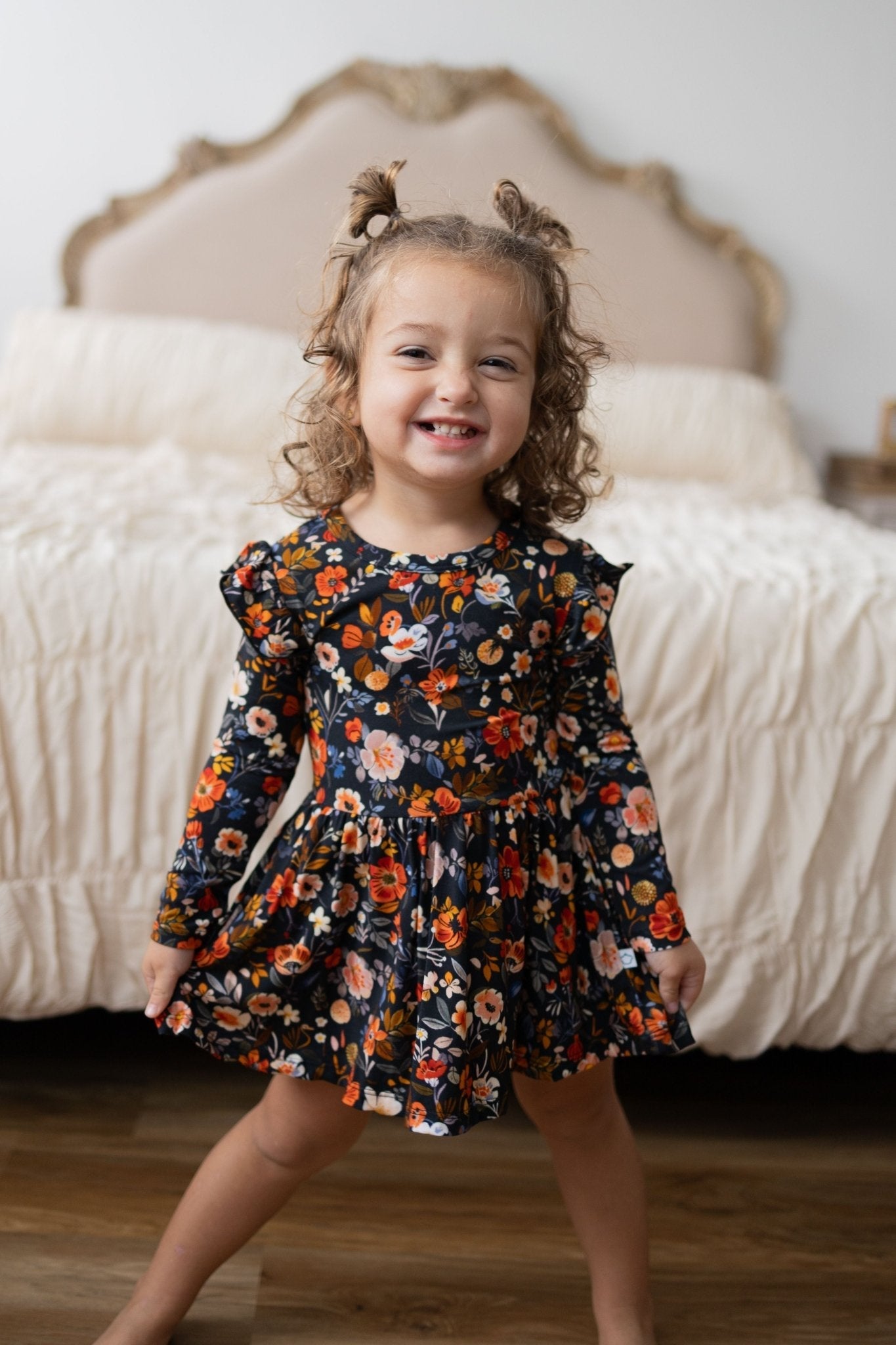 Bodysuit twirl dress in deep navy with autumn floral print, peach trim, and flutter cap long sleeves.