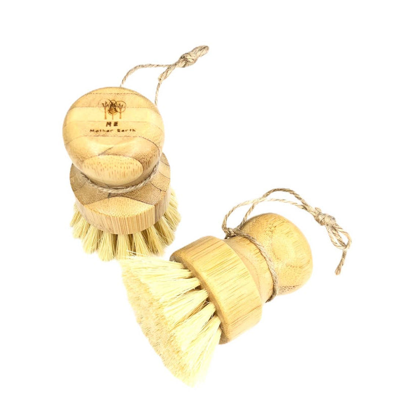 Eco-friendly solid dish soap bar with organic ingredients next to bamboo dish brushes.