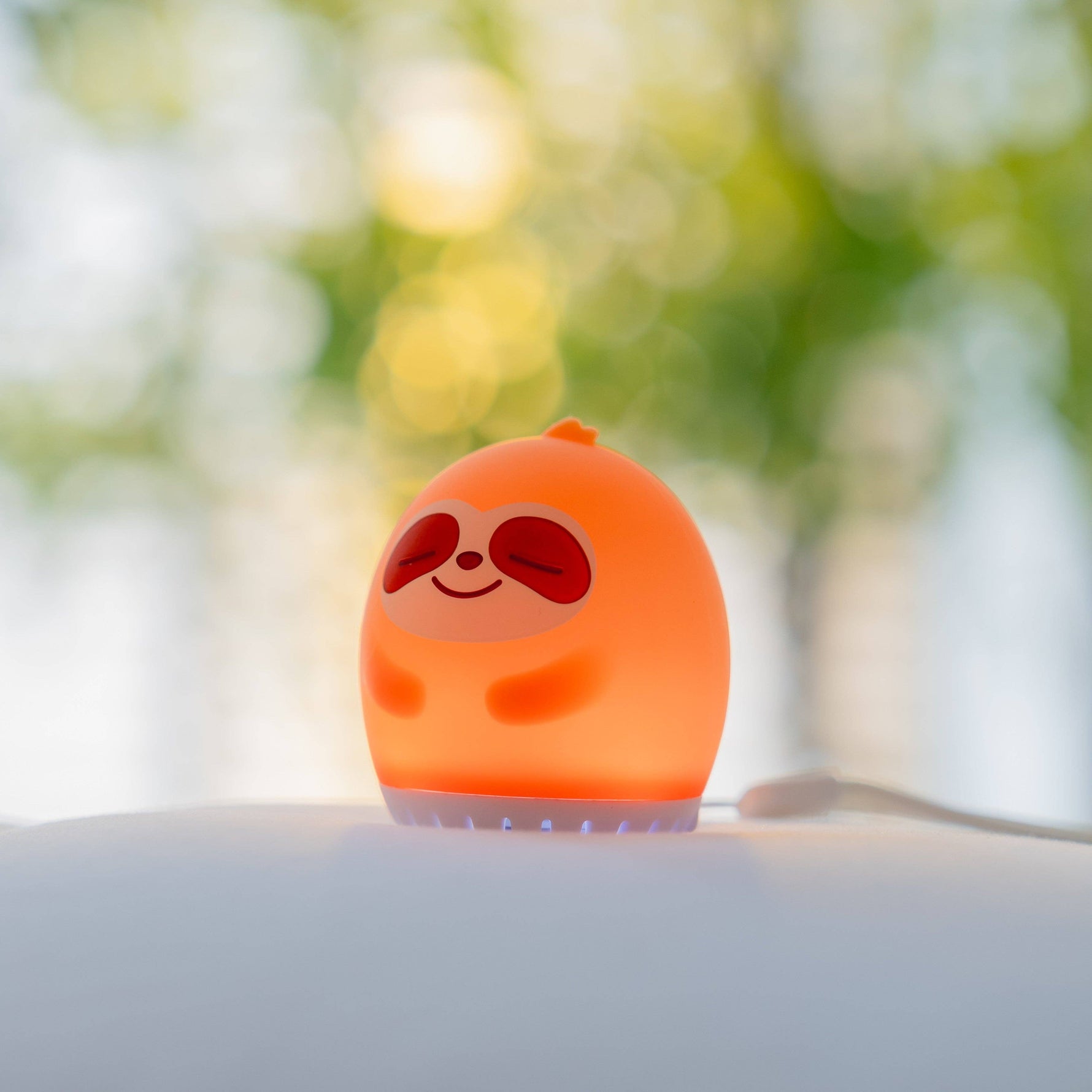 Sleeping Pal portable sloth-shaped night light and sound machine for toddlers.
