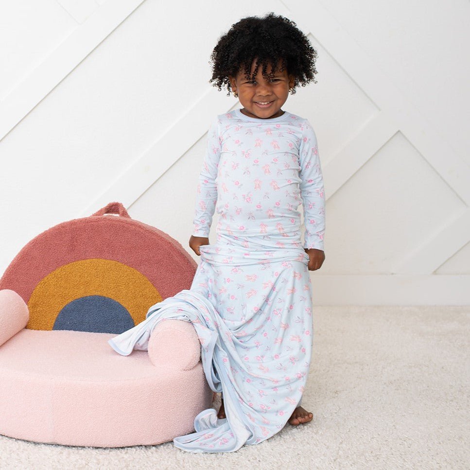 Pink two-piece baby pajama set with a ballerina print, long sleeves, worn by a toddler
