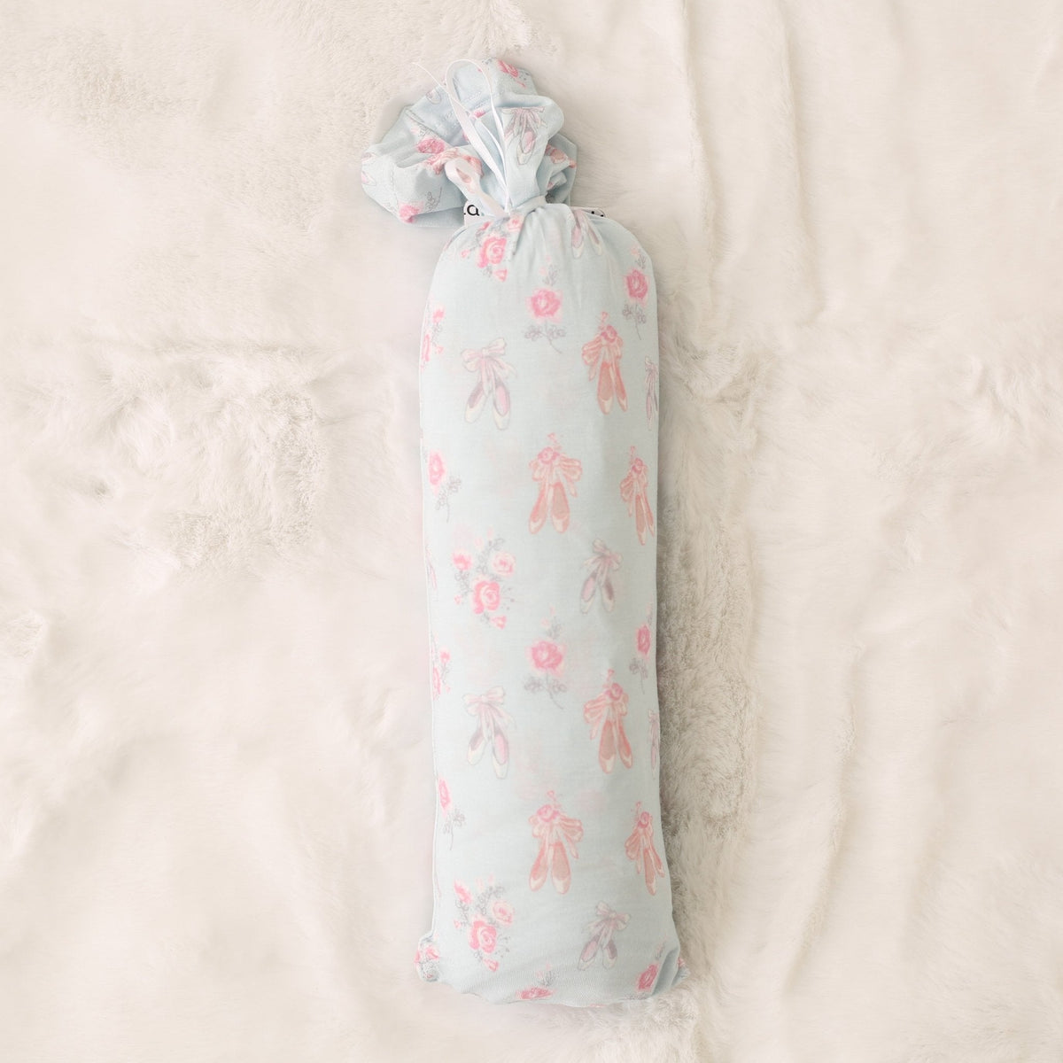 Pink ballerina-print baby swaddle blanket spread out flat in a square shape.