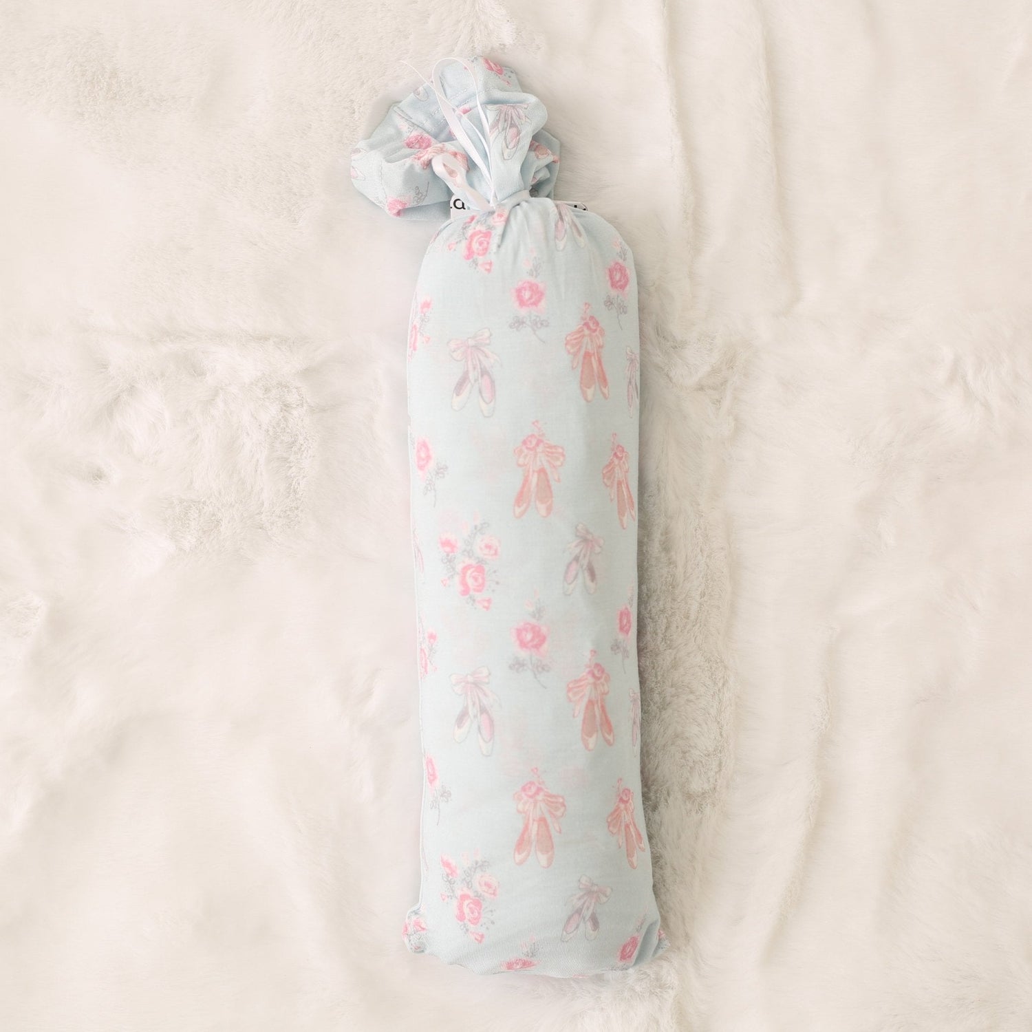 Pink ballerina-print baby swaddle blanket spread out flat in a square shape.