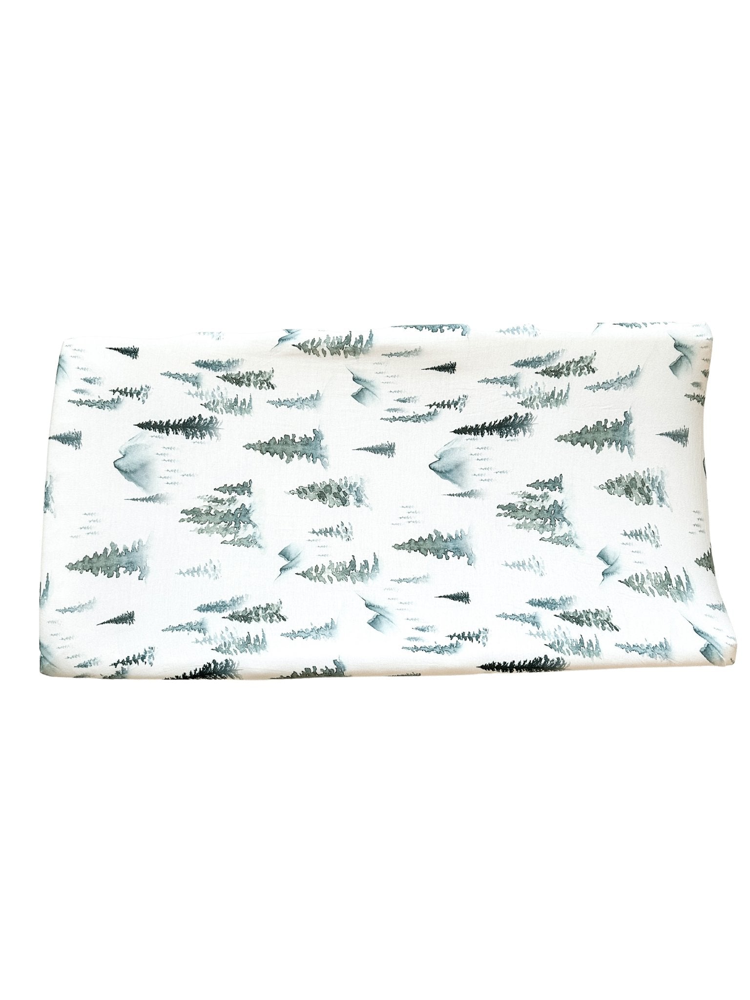 Soft organic bamboo changing pad cover in a green forest print, draped over a changing pad.