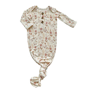 Baby gown in wildflower floral print with fold-over cuffs and a knotted bottom hem.