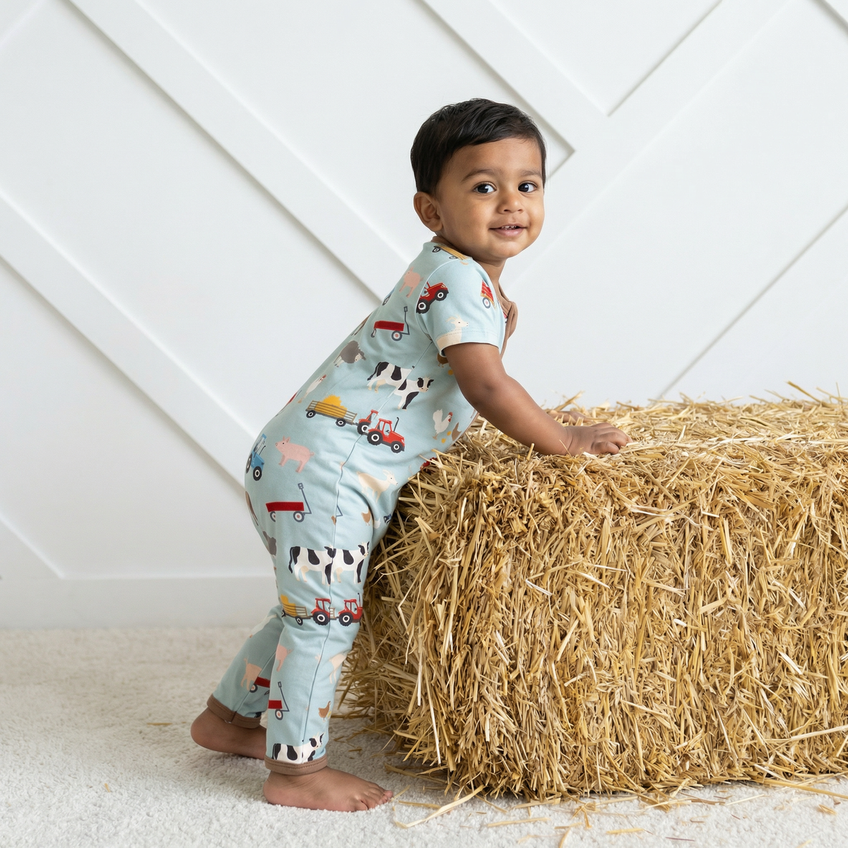Baby convertible romper with barnyard animal print and full-length two-way zipper