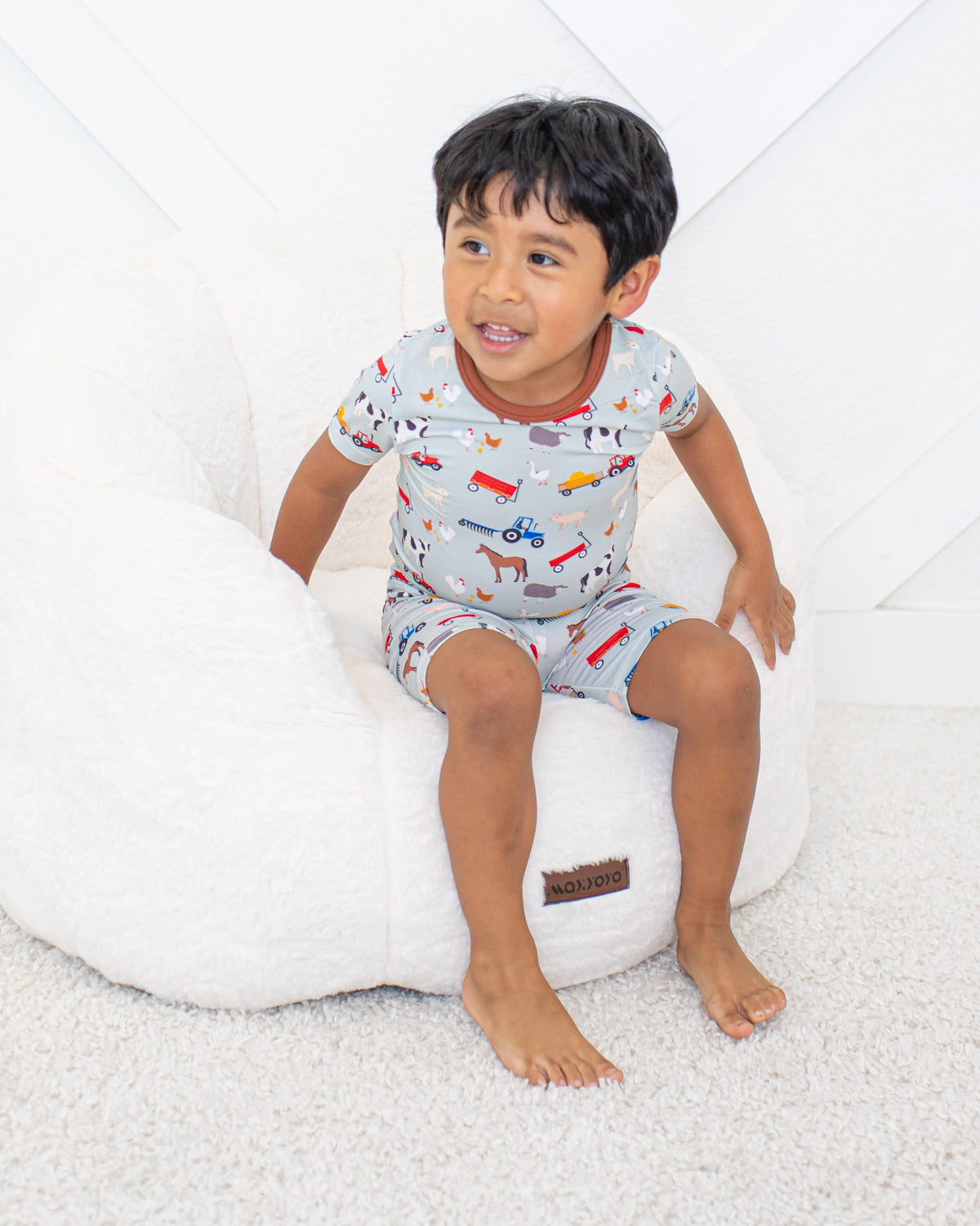 Two-piece baby pajama set with short sleeve top and matching shorts in a barnyard animal print