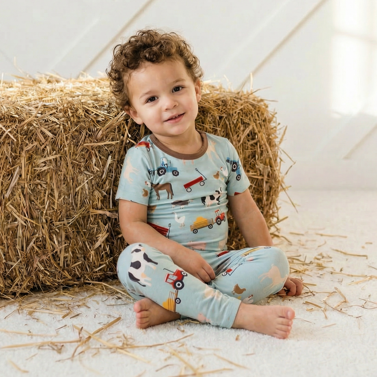 Two-piece pajama set with short sleeve top and long pants in a barnyard animal print
