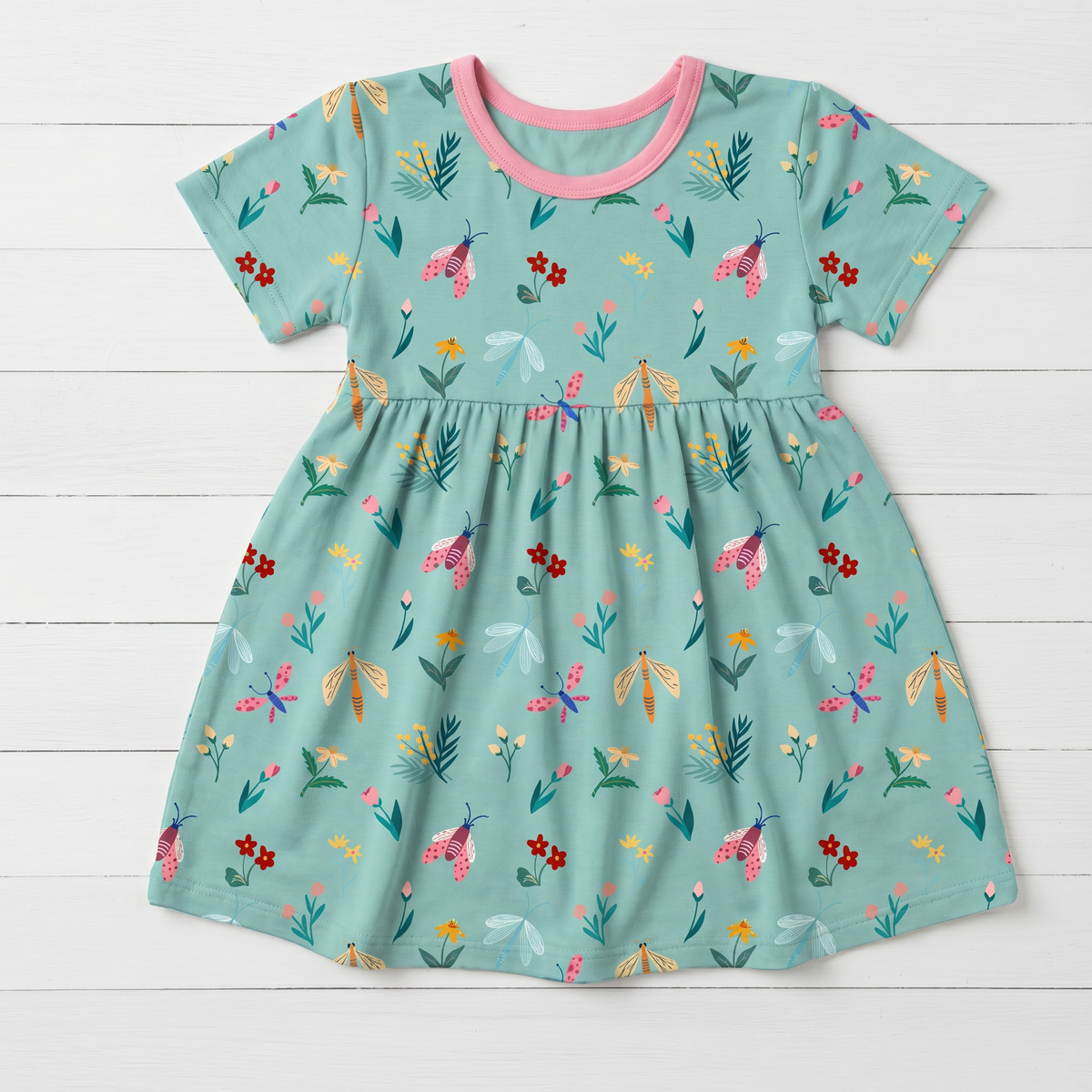 Short sleeve girls' dress in a bloom and bug print, made from bamboo viscose blend fabric