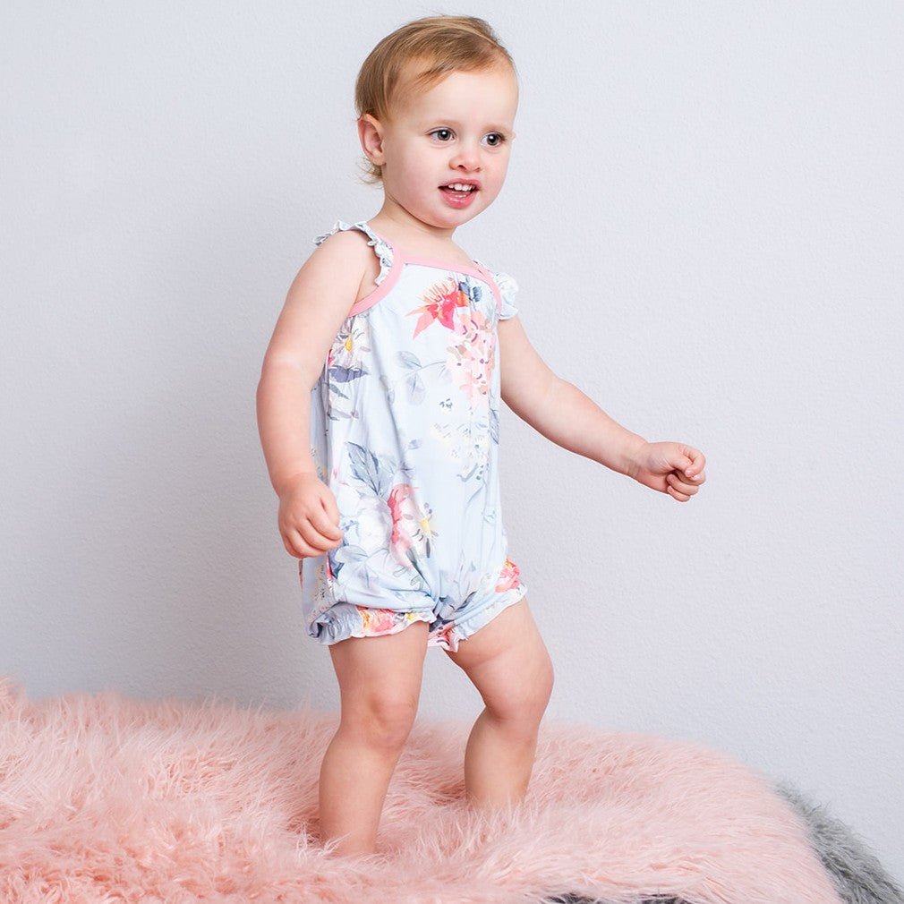 Bubble romper with flutter sleeves in a soft floral blossom print, with snaps along the legs.