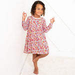 Long-sleeve toddler dress in blush pink with a floral bloom print