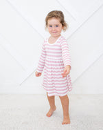 Long sleeve toddler dress in blush and white stripes with a full twirl skirt