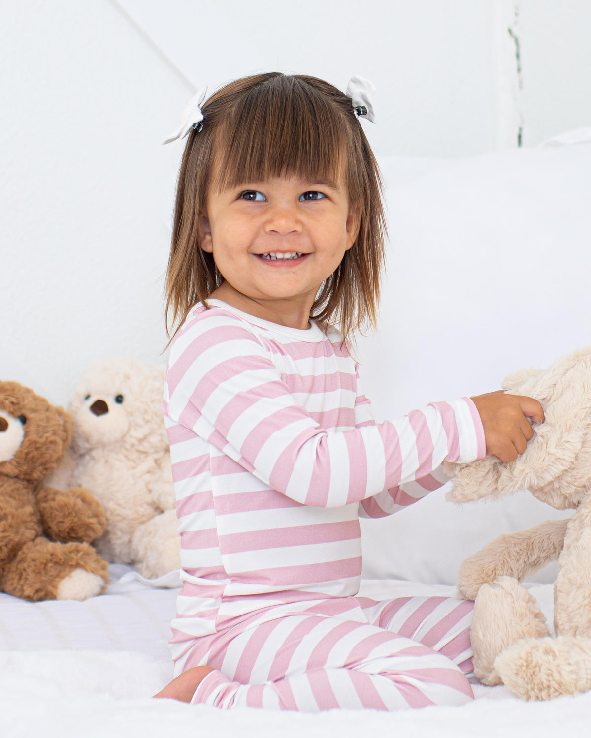 Two-piece long sleeve baby pajama set in blush and white stripes with matching pants