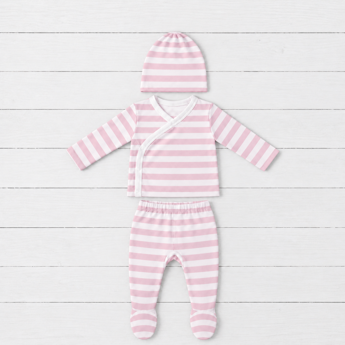 Newborn three-piece set in blush stripes with long sleeve wrap top, footed pants and matching top knot hat