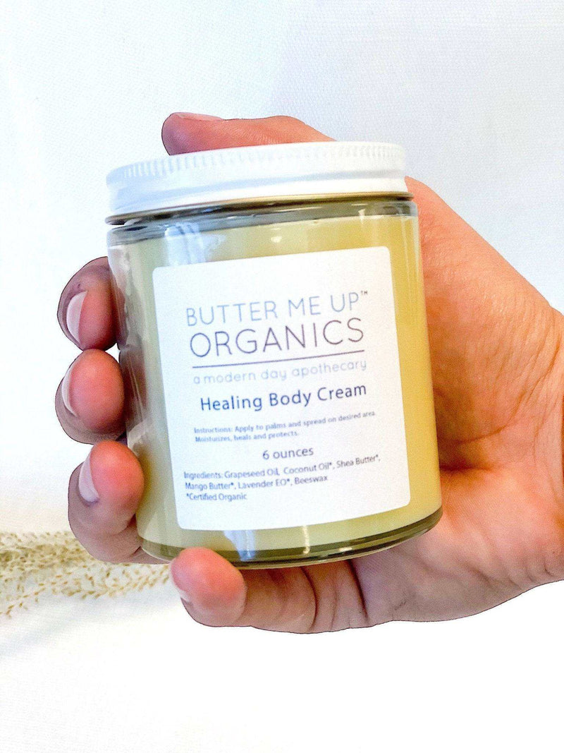 Organic body cream in glass jar for dry winter skin.