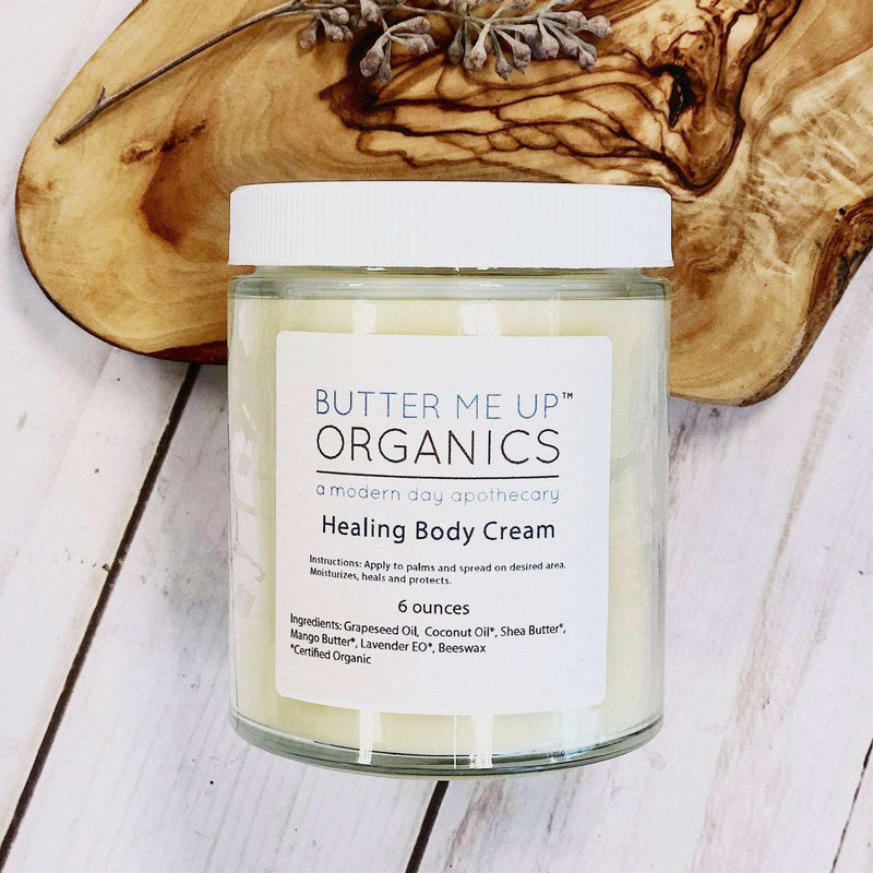 Organic body cream in a glass jar with a metal lid, designed for dry winter skin.