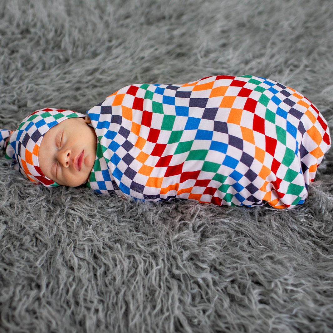 Baby swaddle blanket with a bold two-tone checkered pattern, spread flat to show its square shape