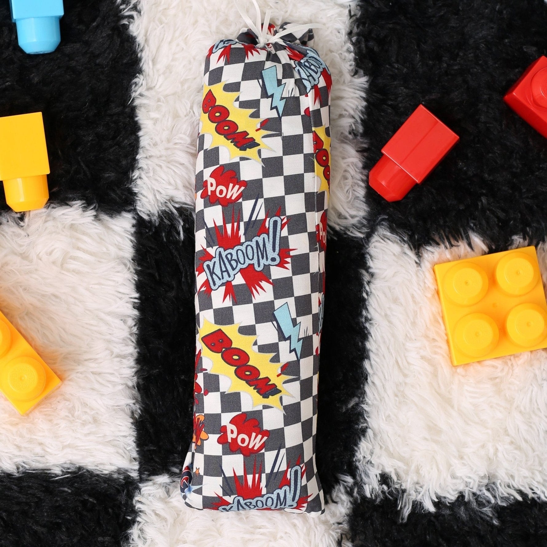 Bamboo baby swaddle blanket in a bold checked pattern, spread flat to show the print.
