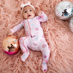 Baby footie pajamas in a disco ball and bows print with a full-length two-way zipper and footed legs.