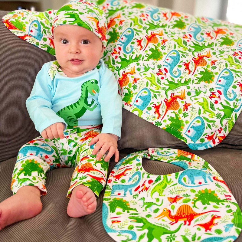 Boys dinosaur onesie set with long sleeves, pants, and matching cap.