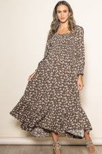 Organic baby girl in a brown floral smocked dress with a unique handkerchief hem.