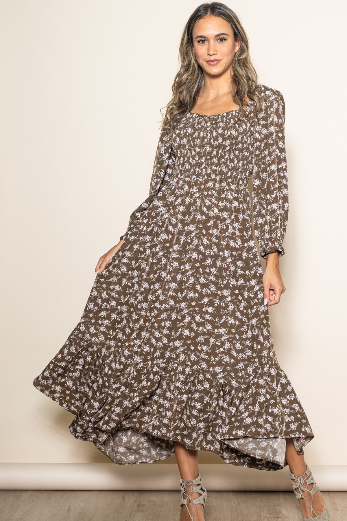 Organic baby girl in a brown floral smocked dress with a unique handkerchief hem.