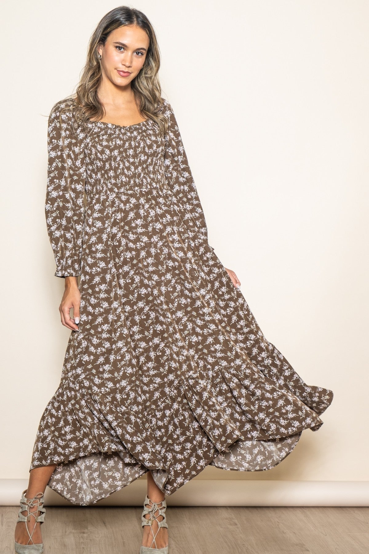 Organic baby girl in a brown floral smocked dress with a unique handkerchief hem.