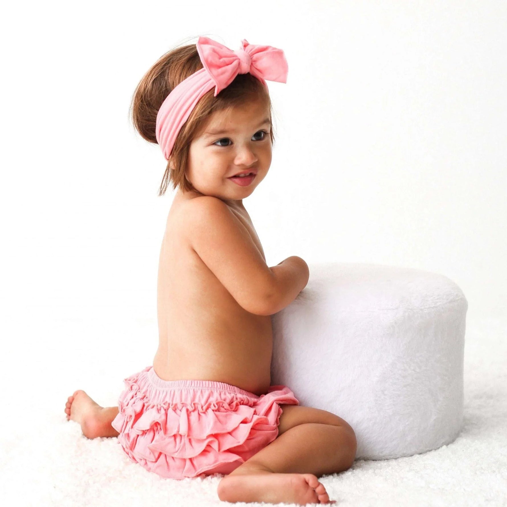 Pink baby bloomer with back ruffles and a matching stretchy headband set