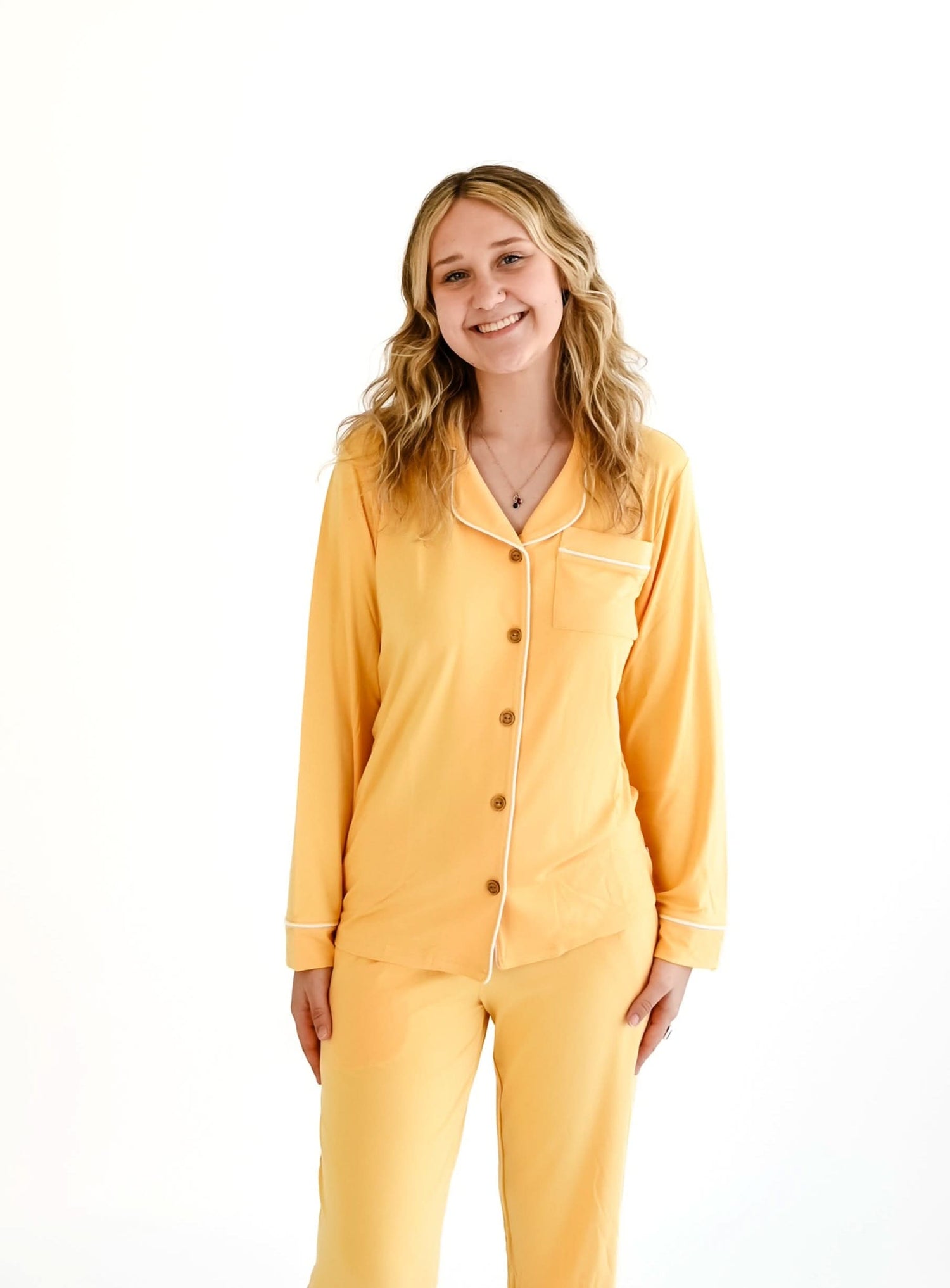 Papaya orange button-up pajama top with a collar and long sleeves, shown laid flat.