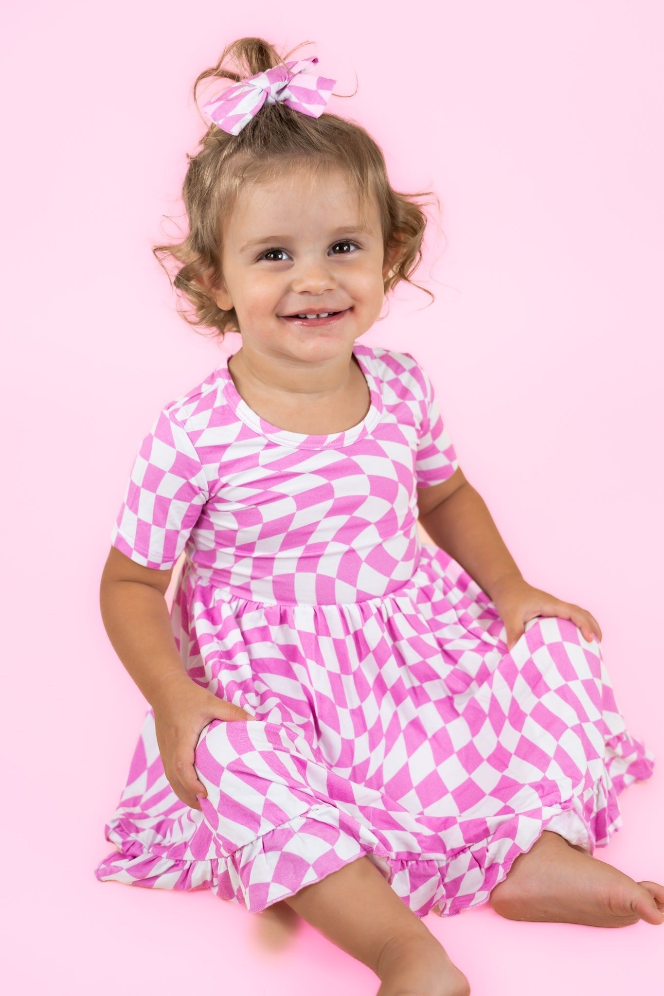 DREAM BIG LITTLE CO BUBBLEGUM WAVY CHECKERS DREAM RUFFLE DRESSEveretts Place