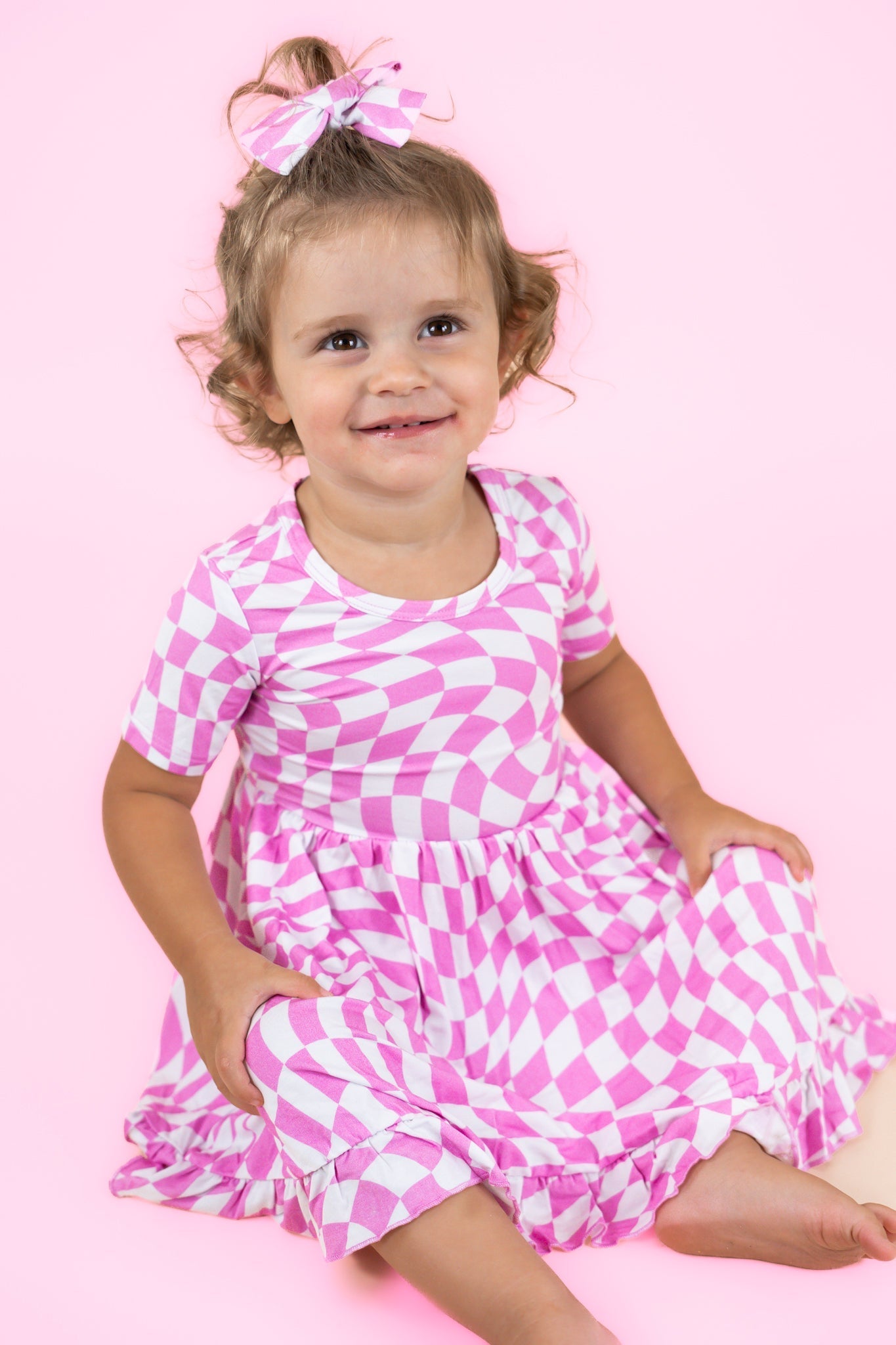 DREAM BIG LITTLE CO BUBBLEGUM WAVY CHECKERS DREAM RUFFLE DRESSEveretts Place